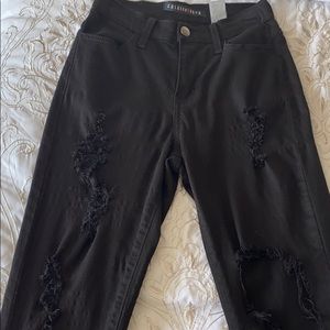 FashionNova black distressed jeans.
